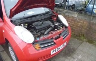Open bonnet Nissan Micra - red Preston