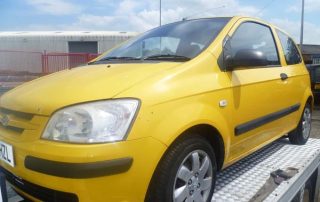 Yellow Hyundai on scrap truck